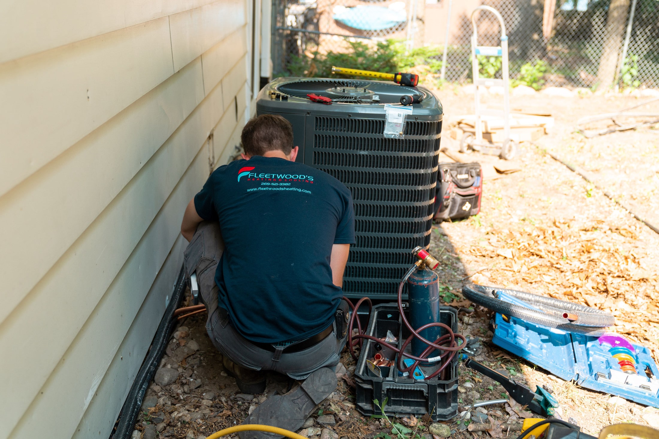 A Fleetwood's technician helping to winterize an AC unit.