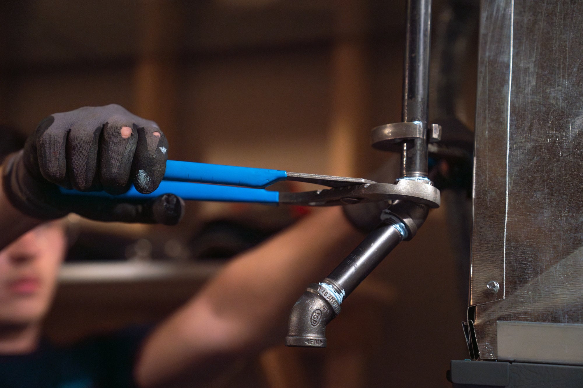 A technician performs a hot water heater repair.